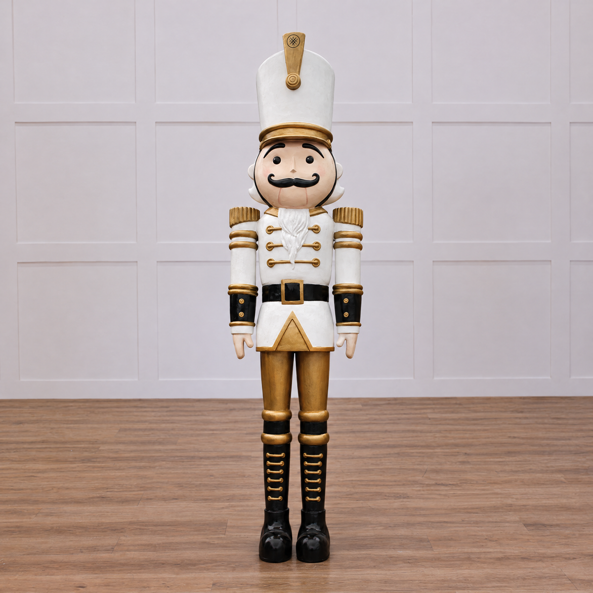 A large white and gold nutcracker soldier with a mustache, wearing a uniform and standing at attention.