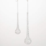Silver teardrop earrings on a white background